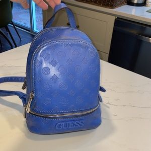 GUESS blue backpack. Multiple outside zippered pockets and inside pockets.